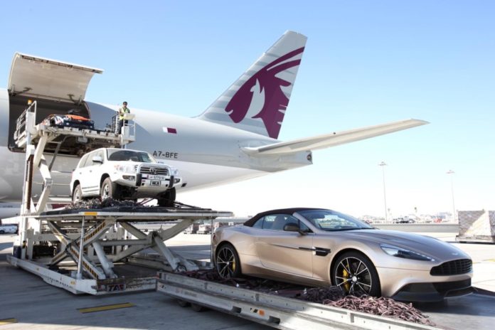 Qatar Airways Cargo unload a sportscar in Doha, Qatar